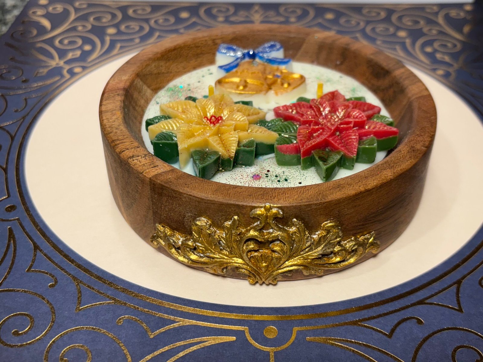 Golden bells & poinsettias in wooden bowl